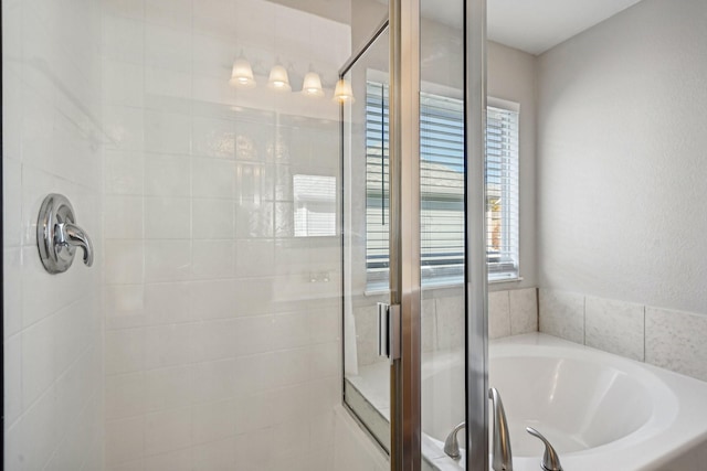 bathroom featuring separate shower and tub