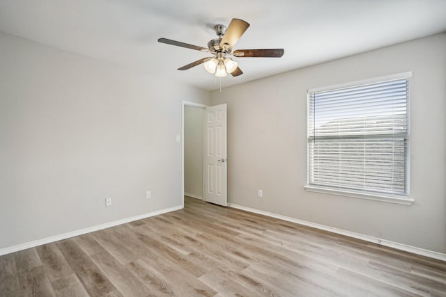 empty room with light wood-type flooring and ceiling fan