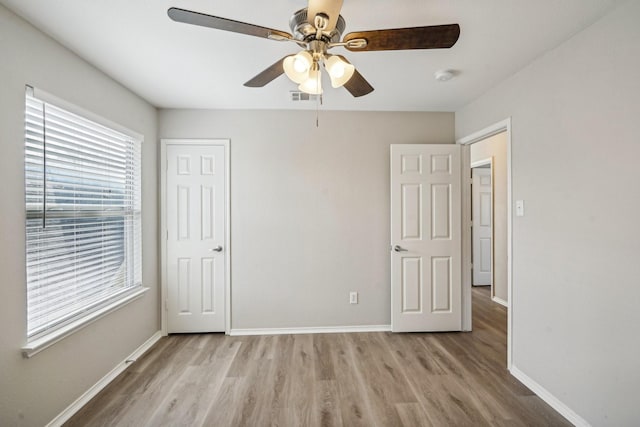 unfurnished bedroom featuring light hardwood / wood-style flooring and ceiling fan