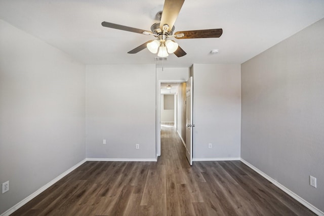 unfurnished room with ceiling fan and dark wood-type flooring