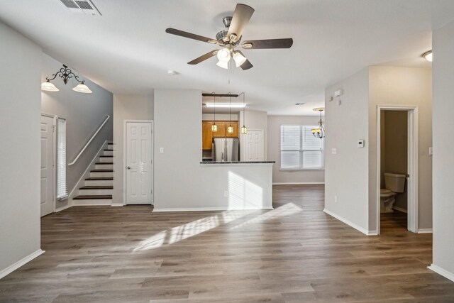 unfurnished living room featuring ceiling fan and dark hardwood / wood-style floors