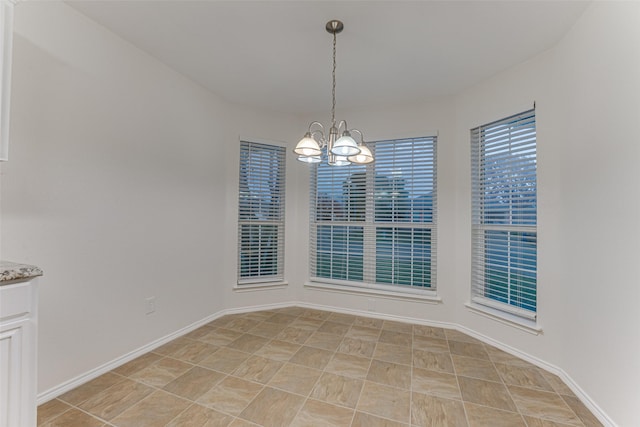 unfurnished dining area featuring a notable chandelier