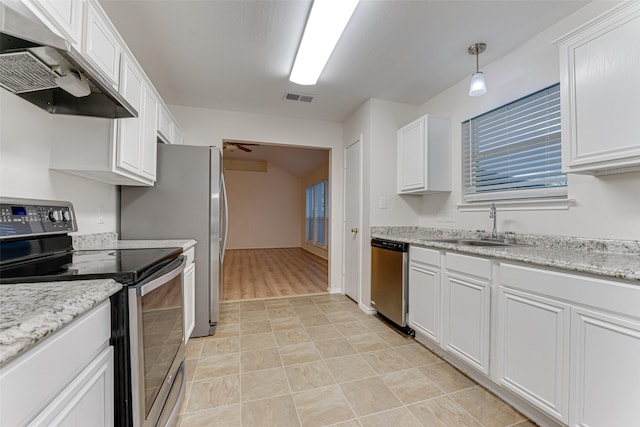 kitchen with white cabinetry, sink, pendant lighting, exhaust hood, and appliances with stainless steel finishes