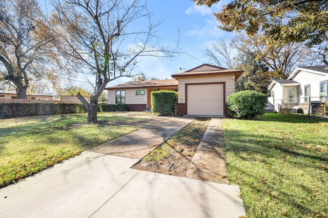 ranch-style house featuring a garage and a front lawn