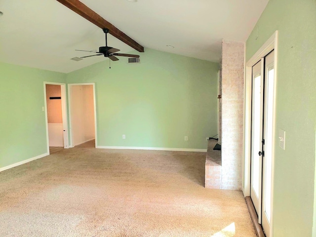 spare room featuring ceiling fan, light colored carpet, and lofted ceiling with beams