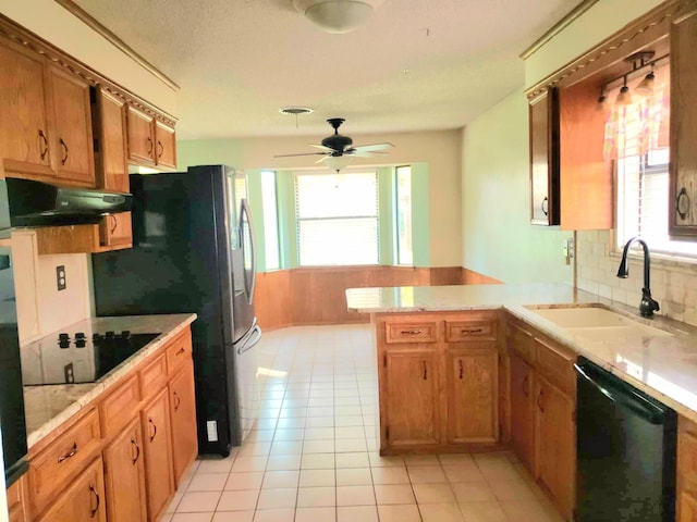 kitchen featuring ceiling fan, sink, kitchen peninsula, light tile patterned flooring, and black appliances