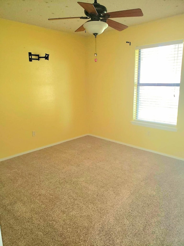 carpeted empty room with ceiling fan