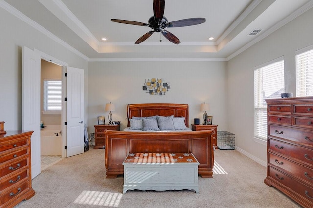 carpeted bedroom featuring ceiling fan, crown molding, a tray ceiling, and multiple windows