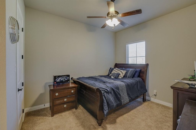 bedroom featuring ceiling fan and light carpet