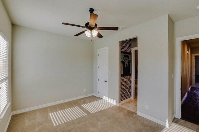 unfurnished bedroom featuring ceiling fan, light colored carpet, and a closet