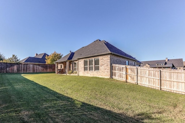 rear view of house with a lawn