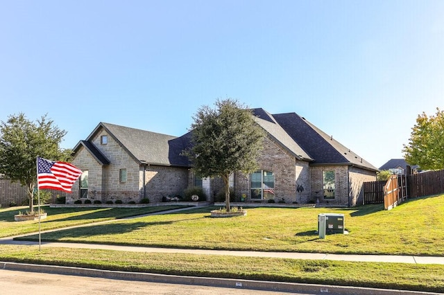 french provincial home featuring a front yard