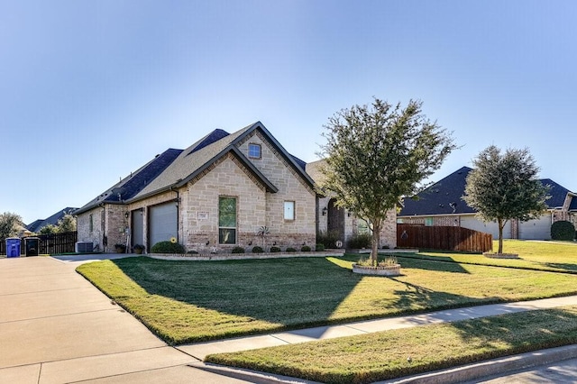 view of front of home with a front lawn and a garage