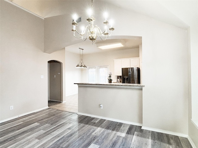 kitchen featuring wood-type flooring, a chandelier, stainless steel fridge with ice dispenser, and white cabinets