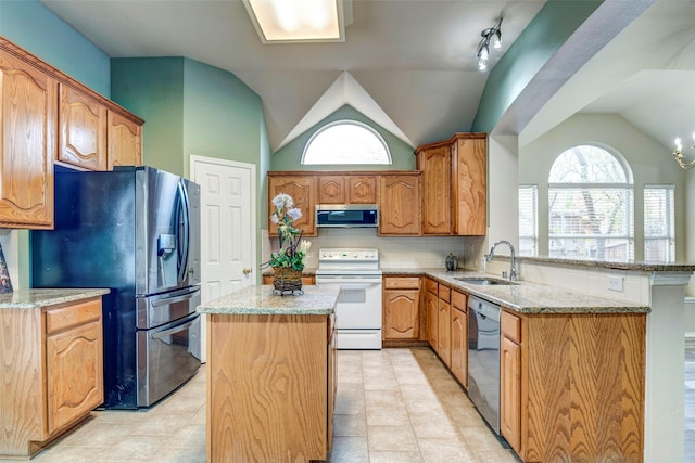 kitchen with a center island, lofted ceiling, sink, decorative backsplash, and appliances with stainless steel finishes