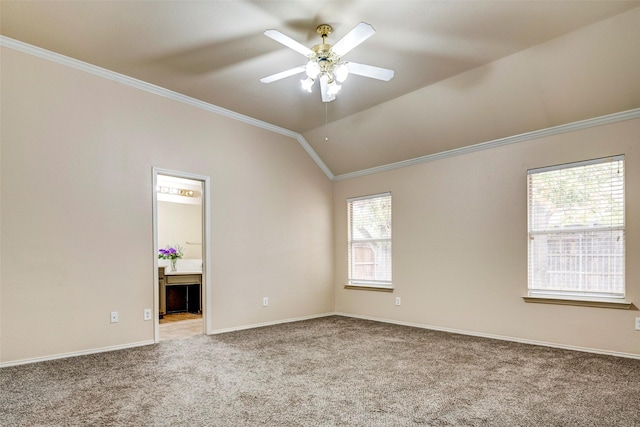 empty room featuring carpet flooring, ceiling fan, lofted ceiling, and ornamental molding