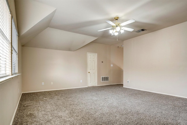 carpeted empty room with ceiling fan and lofted ceiling