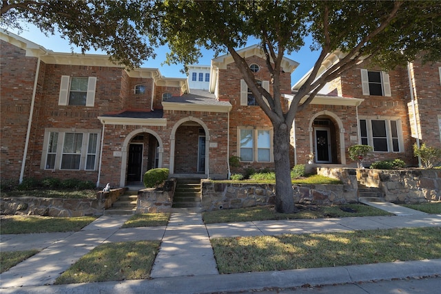 view of front of home featuring brick siding