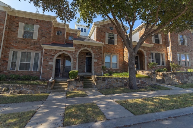 townhome / multi-family property featuring brick siding