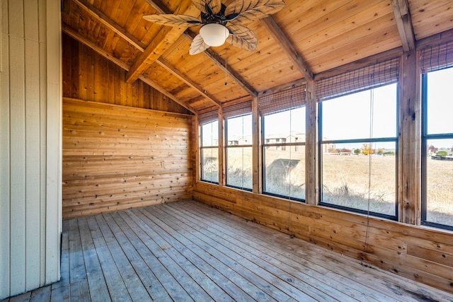 unfurnished sunroom with vaulted ceiling with beams, a wealth of natural light, ceiling fan, and wooden ceiling