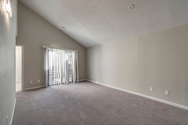 carpeted spare room with a textured ceiling and high vaulted ceiling