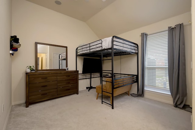 carpeted bedroom with vaulted ceiling