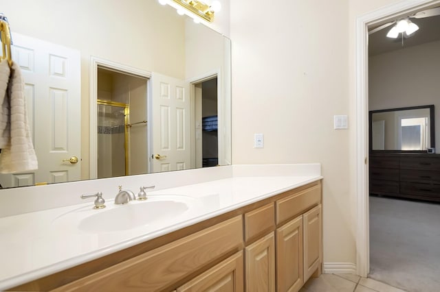 bathroom with vanity, tile patterned floors, ceiling fan, and walk in shower