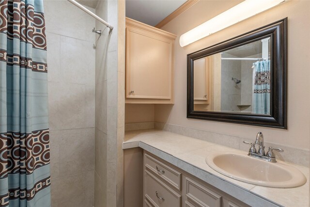 bathroom with walk in shower, vanity, and ornamental molding