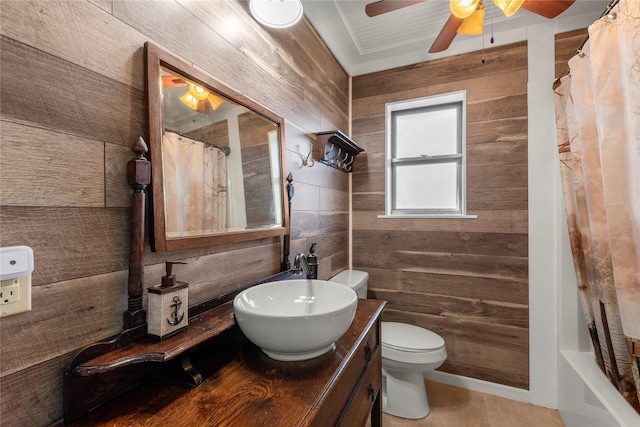 bathroom with ceiling fan, wood walls, vanity, and toilet