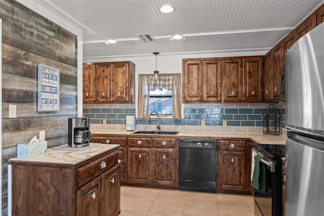 kitchen featuring decorative backsplash, appliances with stainless steel finishes, sink, light tile patterned floors, and pendant lighting