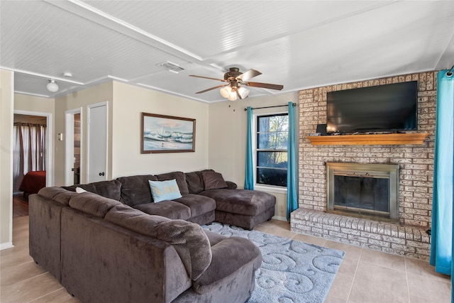 tiled living room featuring ceiling fan and a brick fireplace