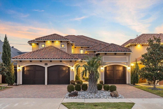 mediterranean / spanish-style house featuring a garage