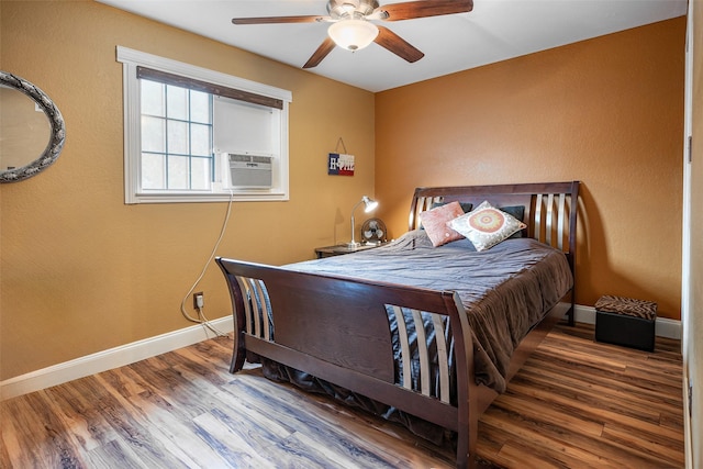 bedroom with ceiling fan, cooling unit, and dark wood-type flooring