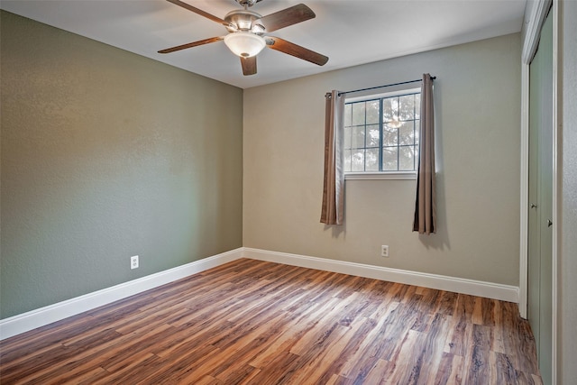 interior space featuring ceiling fan, a closet, and hardwood / wood-style flooring