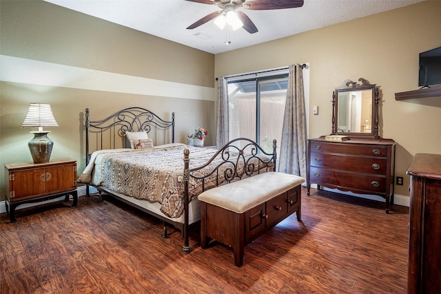 bedroom with ceiling fan, dark wood-type flooring, and a textured ceiling