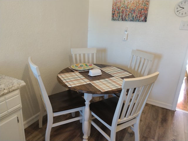 dining area featuring dark hardwood / wood-style floors