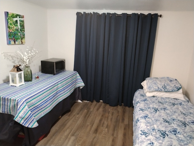 bedroom with hardwood / wood-style floors