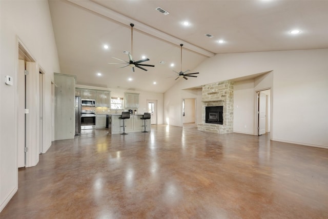 unfurnished living room with high vaulted ceiling, ceiling fan, a fireplace, concrete floors, and beamed ceiling