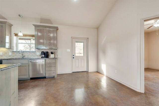 kitchen featuring tasteful backsplash, dishwasher, a healthy amount of sunlight, and decorative light fixtures