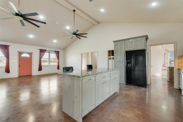 kitchen featuring high vaulted ceiling, black fridge, light stone countertops, beam ceiling, and a kitchen island