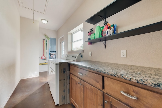 kitchen featuring stone countertops and washer / dryer