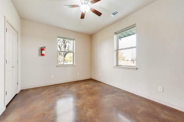 interior space featuring ceiling fan and concrete flooring