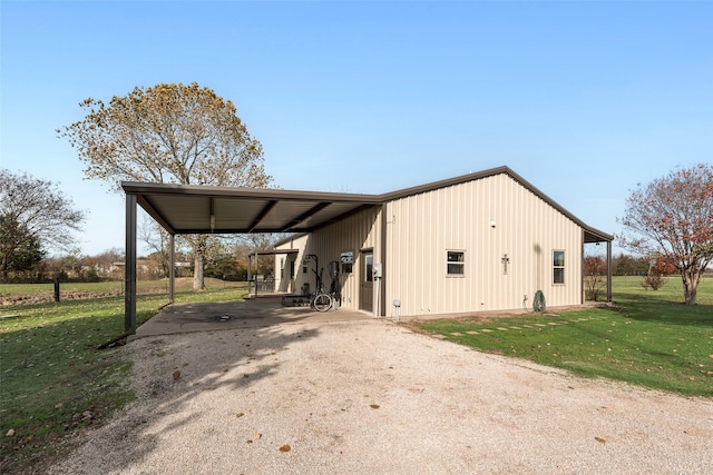 view of home's exterior with a yard and a carport