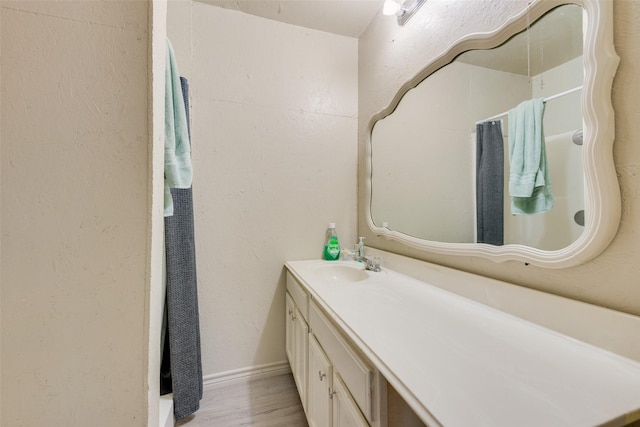 bathroom featuring vanity and hardwood / wood-style flooring