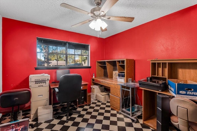 office area with ceiling fan and a textured ceiling