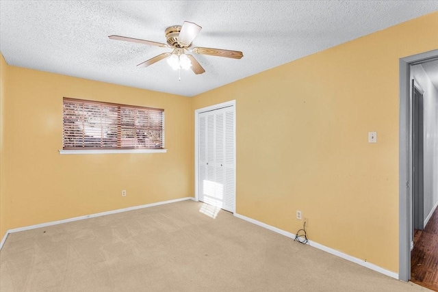 unfurnished bedroom with a textured ceiling, a closet, and ceiling fan