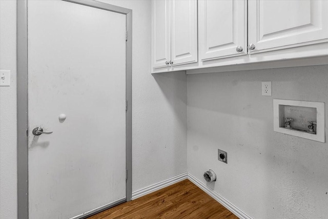 laundry room with cabinets, hookup for a washing machine, dark hardwood / wood-style flooring, and electric dryer hookup