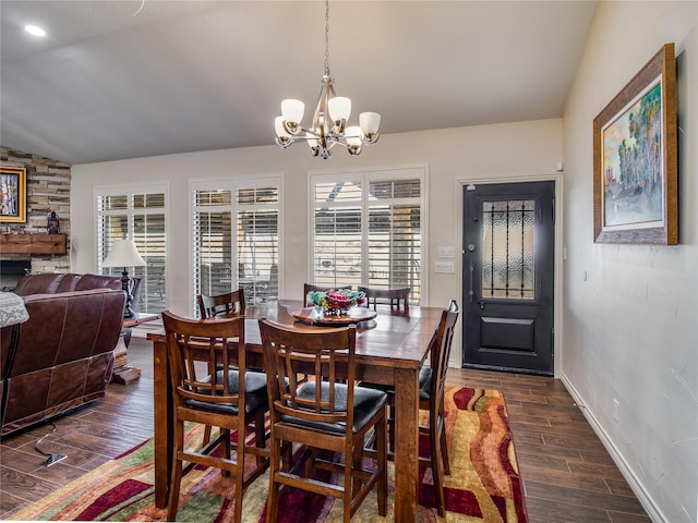 dining room with a chandelier, dark wood-type flooring, and vaulted ceiling