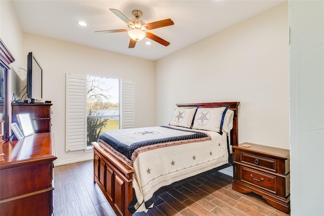 bedroom with ceiling fan and dark hardwood / wood-style flooring