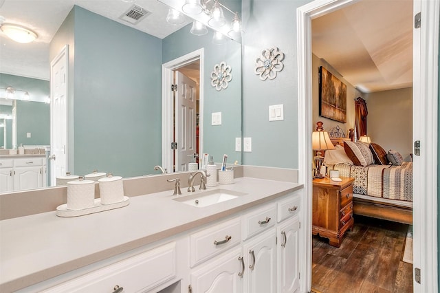 bathroom with vanity and wood-type flooring